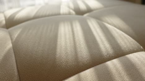 beige sofa fabric with sunlight shadows