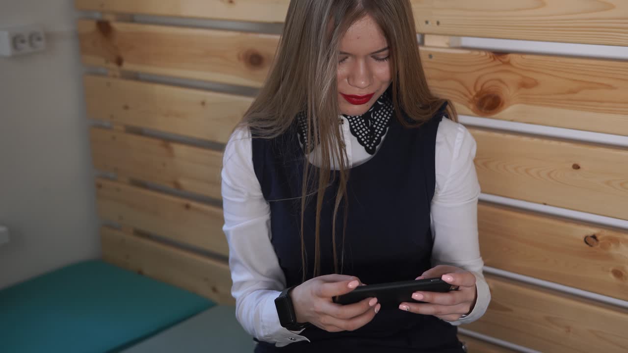 Young Woman Using Smartphone in Office
