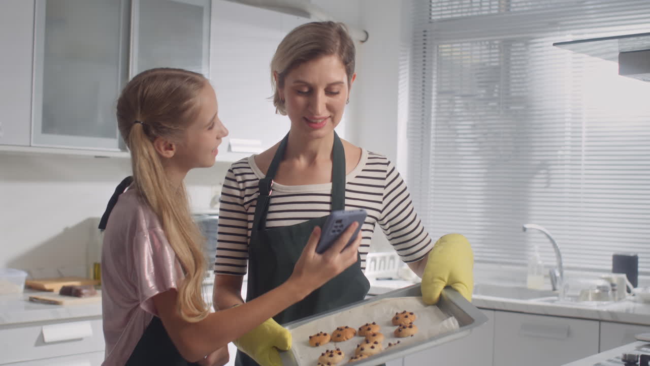 Girl Taking Photos of Baked with Mother Cookies on Smartphone