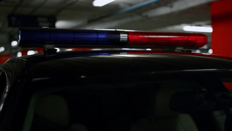 Red-and-blue-lights-flashing-on-police-car.-Police-flasher-glowing-on-vehicle