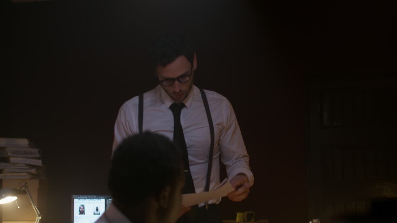 Businessmen reviewing documents at night