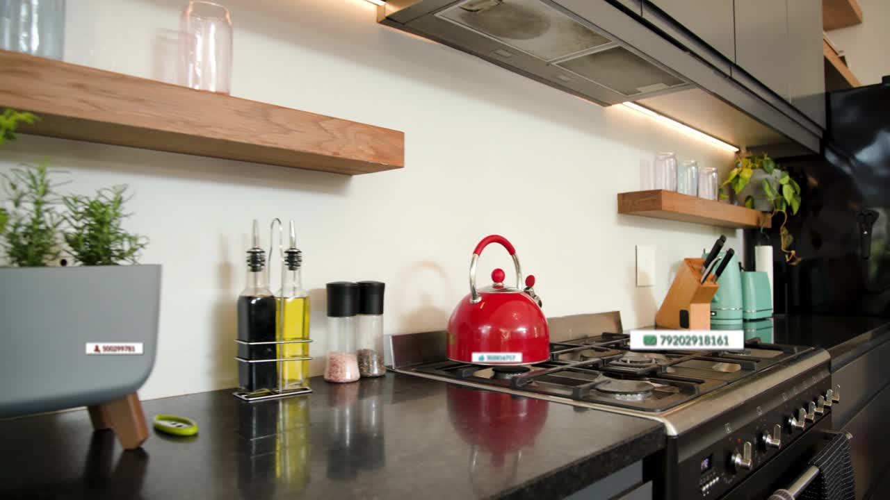 Camera panning left, AR labels appearing and aligning to annotate red kettle and mint appliances