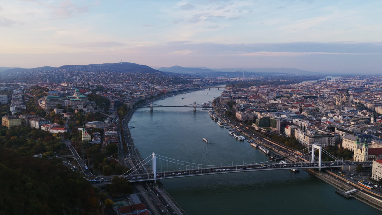 The Elisabeth Bridge and Chain Bridge span the Danube, connecting Buda and Pest in a stunning panorama of Budapest’s riverfront at dusk