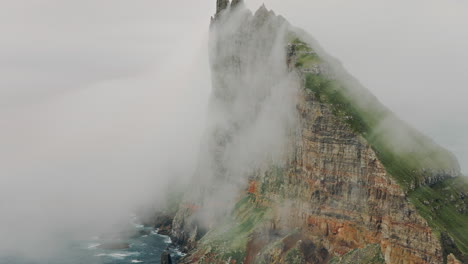 dramatic cliff face shrouded in fog