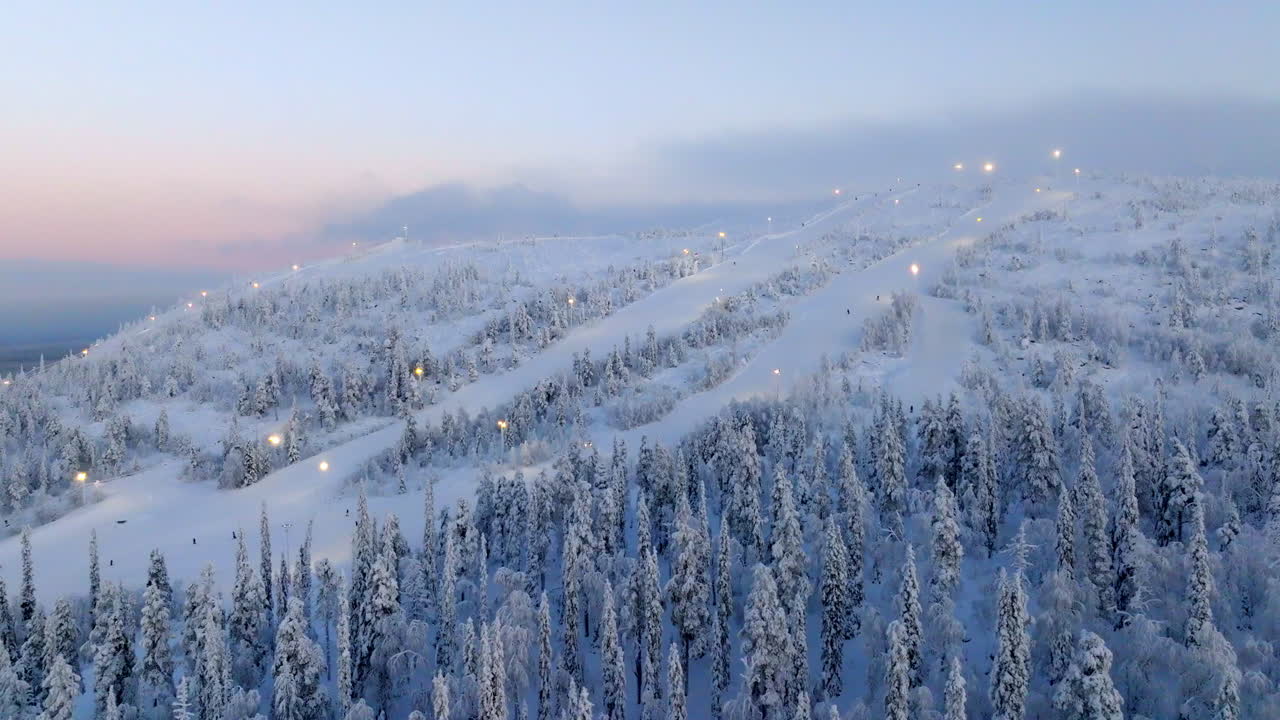Panoramic drone shot circling the slopes of Sallatunturi, sunrise in Finland
