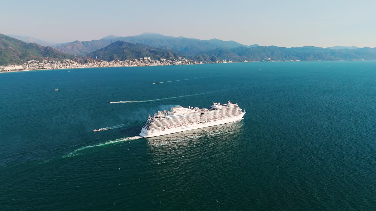 Aerial shot of cruise ship in Banderas Bay, in the background the city with its natural surroundings. Puerto Vallarta, Mexico