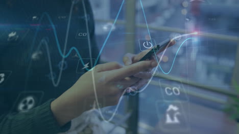 animation of graphs, icons over midsection of caucasian woman scrolling on smartphone