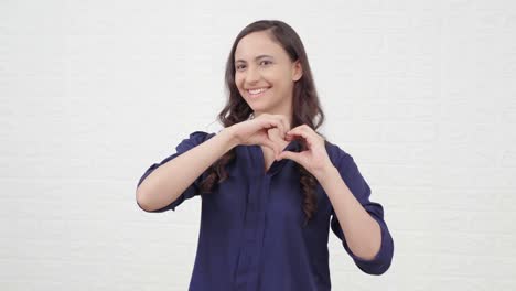 indian girl showing heart gesture