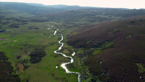 meander winding river along canyon base, sunlight shines and glimmers sierra segundera