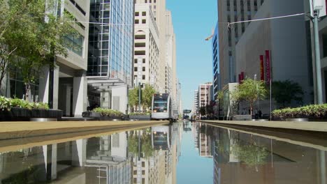 A-rapid-transit-train-moves-quickly-through-downtown-Houston-with-fountains-dancing-5