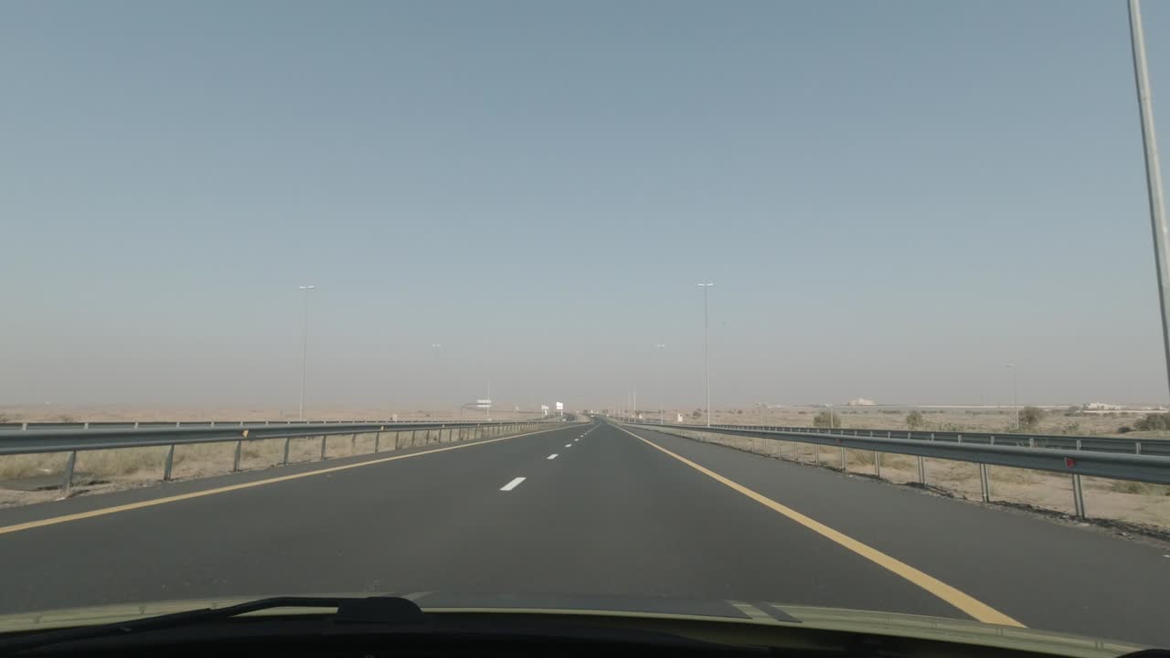 A black pick up truck speeding off on the highway.