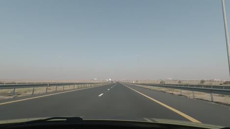a black pick up truck speeding off on the highway.