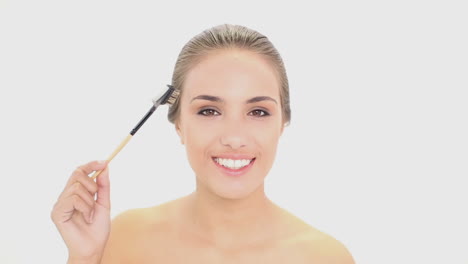 beautiful model using an eyebrow brush