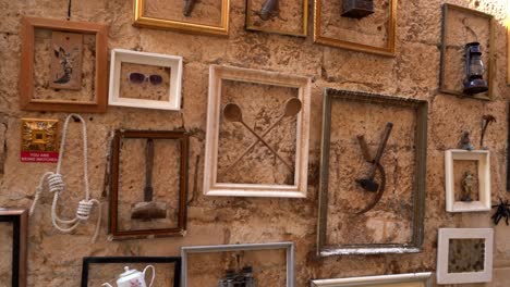 framed objects as eclectic wall decoration in local bar in korcula