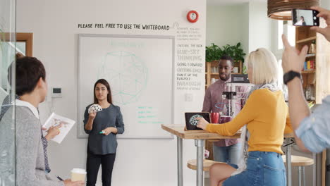 diverse group business meeting female team leader presenting crowdsourcing plan idea to tech startup investors in trendy hipster office holding 3d printer object geodesic dome