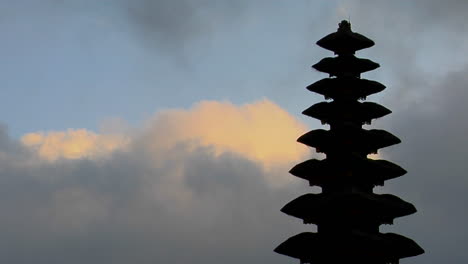 part of a balinese temple stands in silhouette 3