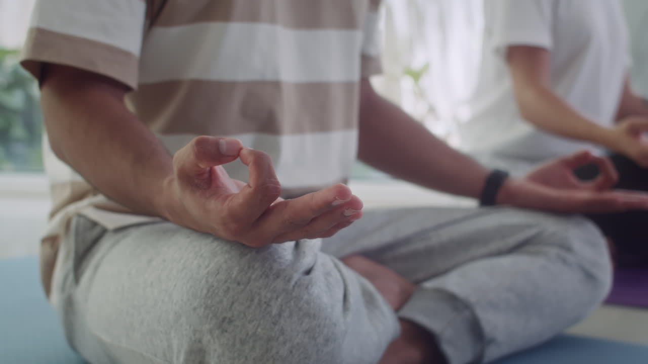 Man and Woman Meditating on Floor during Yoga Workout
