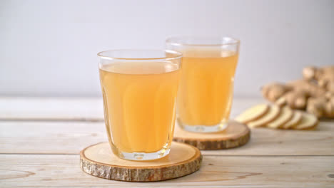 fresh and hot ginger juice glass with ginger roots - healthy drink style