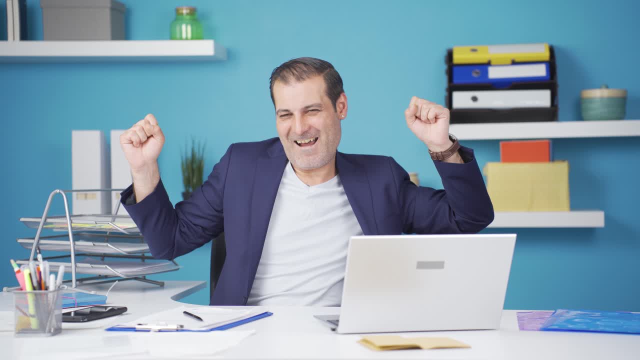 Cheerful businessman dancing looking at camera.
