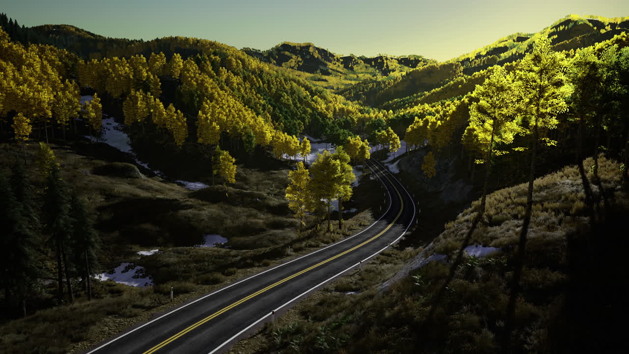 Beautiful winding road through autumn forest at sunset in mountainous area