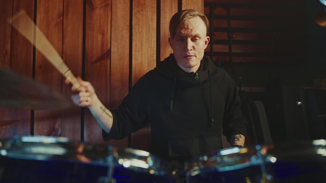 Drummer Playing Drums in a Studio