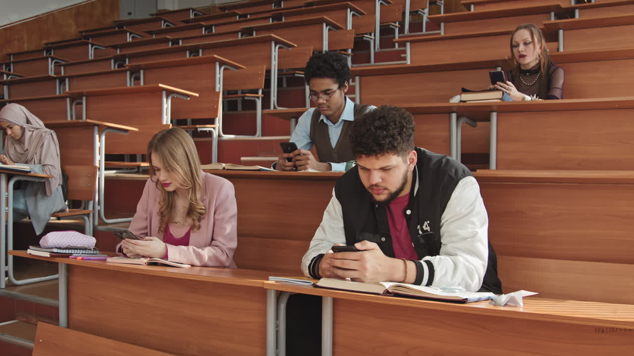 University Students Scrolling through Smartphones in Class