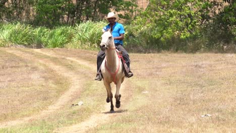 a cowboy in costa rica, riding a running horse