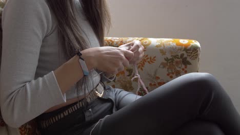 medium view of woman working with hands to crochet and knit a piece