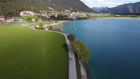 promenade for bikers and pedestrians by beautiful lake in mountains