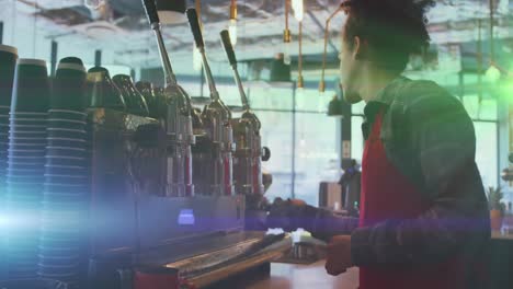 Animation-of-light-spots-over-biracial-man-cleaning-coffee-machine-in-cafe