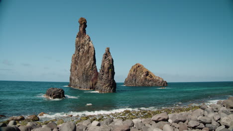 tall lava rocks in ocean, islet towers in ribeira da janela, madeira, portugal - wide static shot