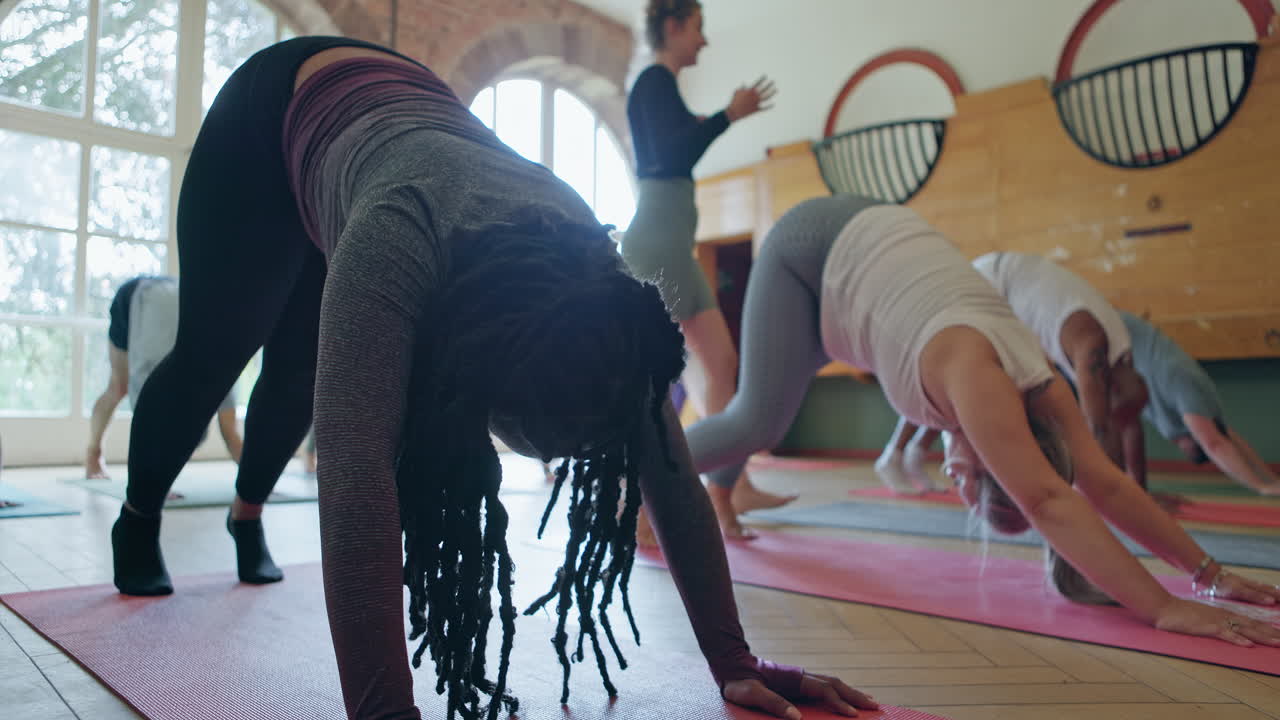 Group Yoga Class Practicing Downward Dog Pose