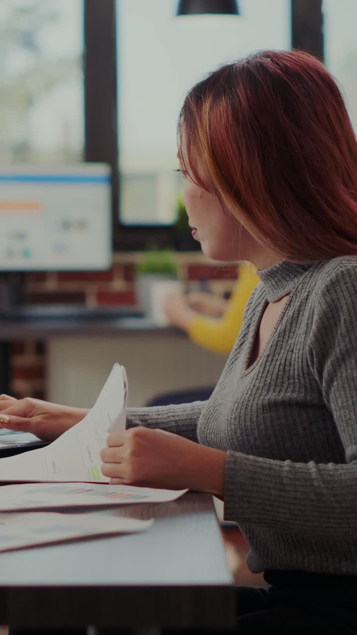 Asian woman working with reports in office