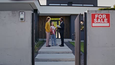 home for sale with potential buyers and real estate agent
