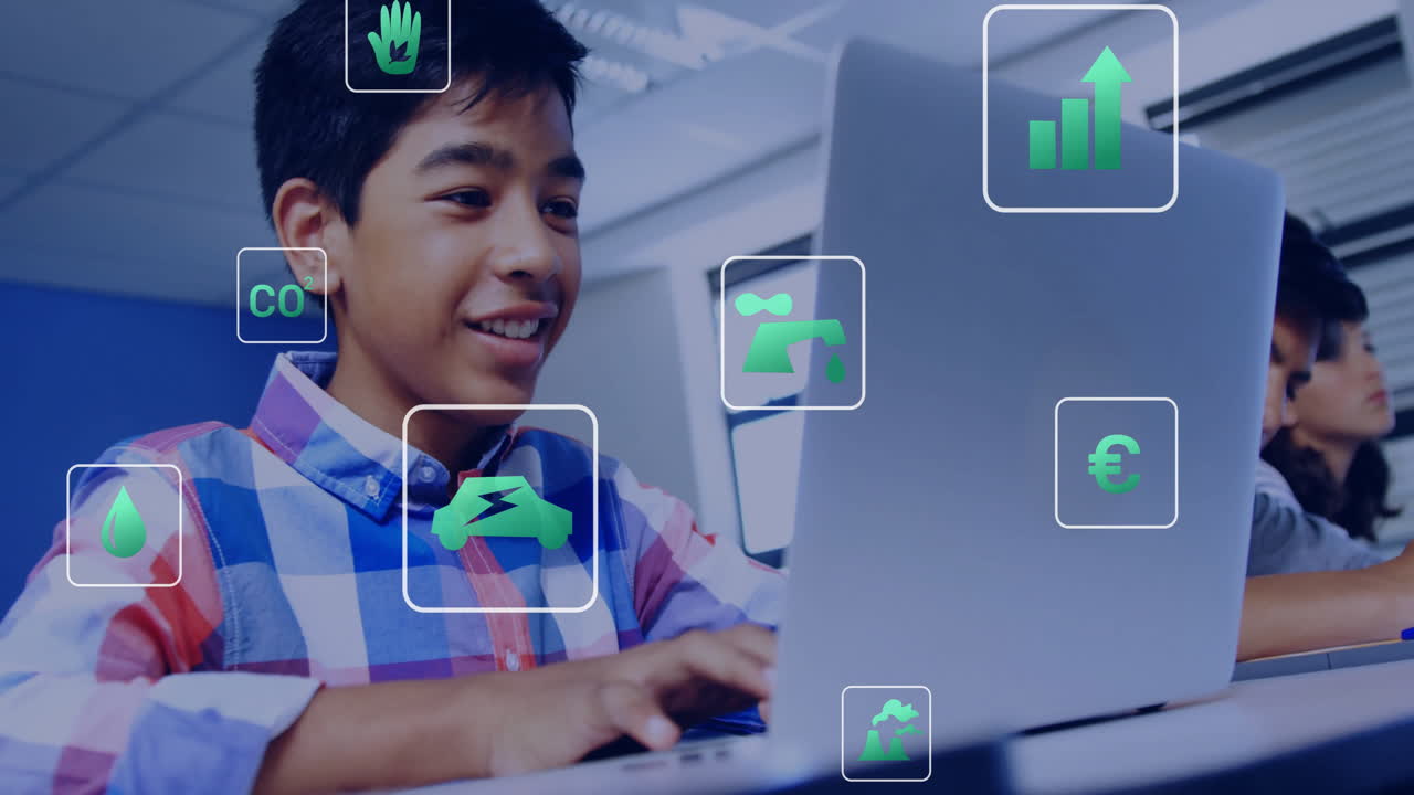 In school, smiling boy using laptop with animation of environmental icons