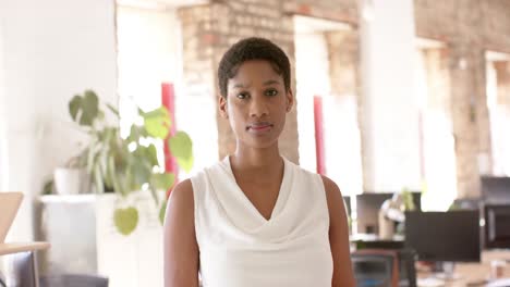 Portrait-of-happy-african-american-casual-businesswoman-in-creative-office-in-slow-motion