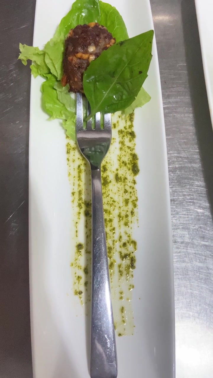 Gourmet Appetizer Served on a White Plate with Pesto Sauce