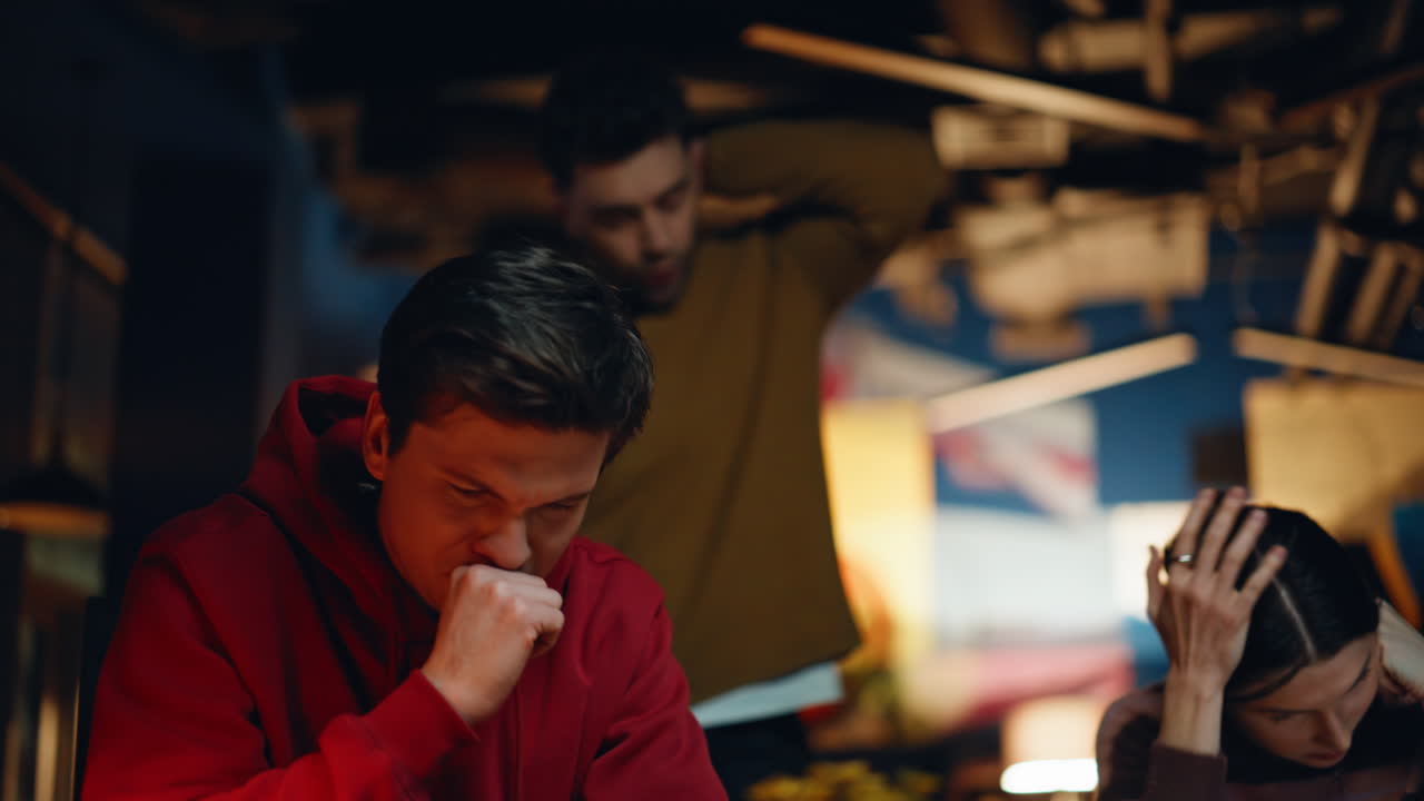 A group of upset people are gathered at a table