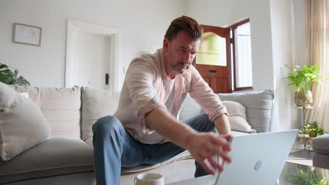 senior man walking through front door at home, wearing casual shirt