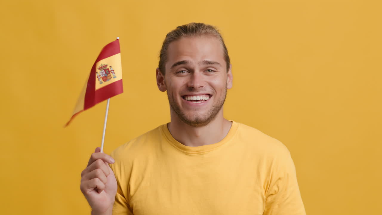 Smiling Man Holding Spanish Flag
