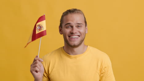 smiling man holding spanish flag