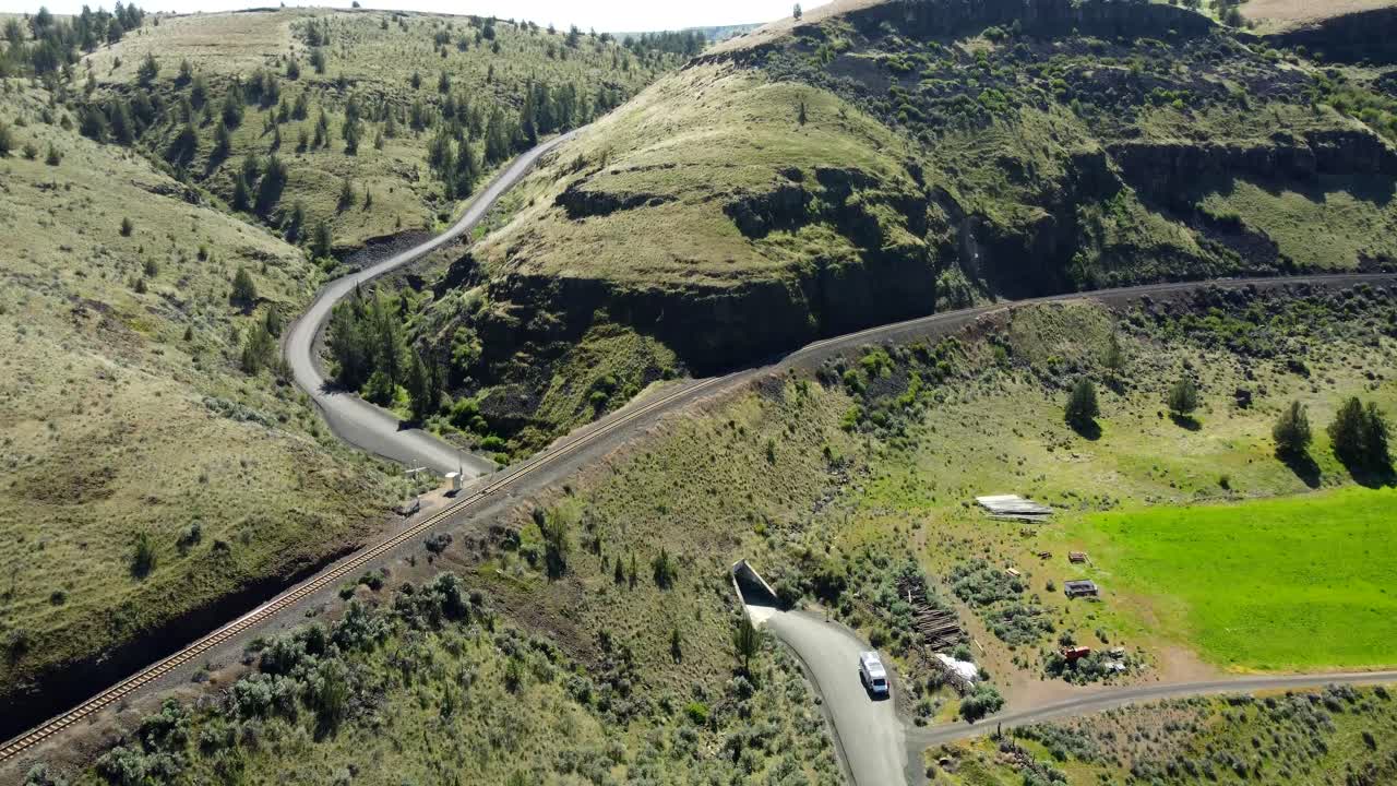 US, Oregon, Madras, Trout Creek, 2025-04-19 - Drone view one vehicle tunnel under a railroad train track in a canyon in central Oregon
