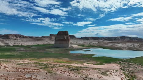 lone rock in lake powell with low water level during drought season in arizona, usa