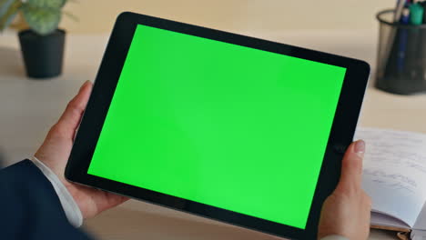 unrecognizable businesswoman watching greenscreen tablet working office closeup