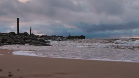 The-sea-wave-washes-away-the-old-abandoned-stone-pier