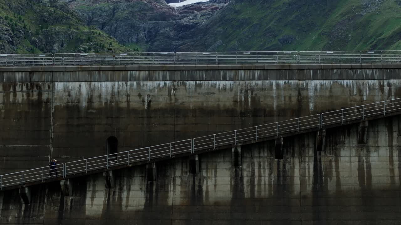 Aerial drone pedestal up of Fellaria dam of Valmalenco in Italy revealing Lake Gera