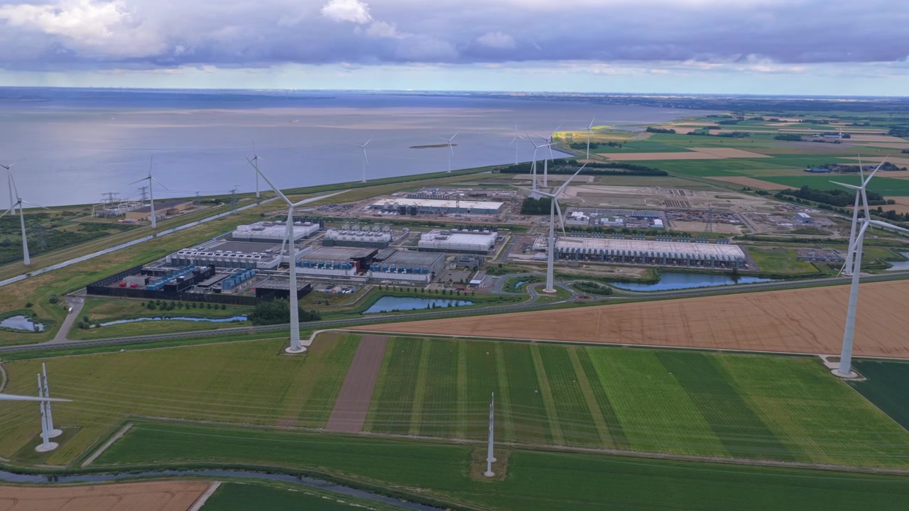 Aerial view of the google data center in eemshaven, netherlands, powered by surrounding wind turbines producing clean, renewable energy