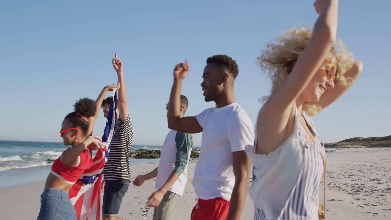 Young adult friends having fun walking on a beach 4k