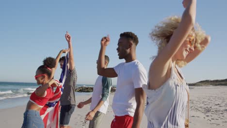 young adult friends having fun walking on a beach 4k