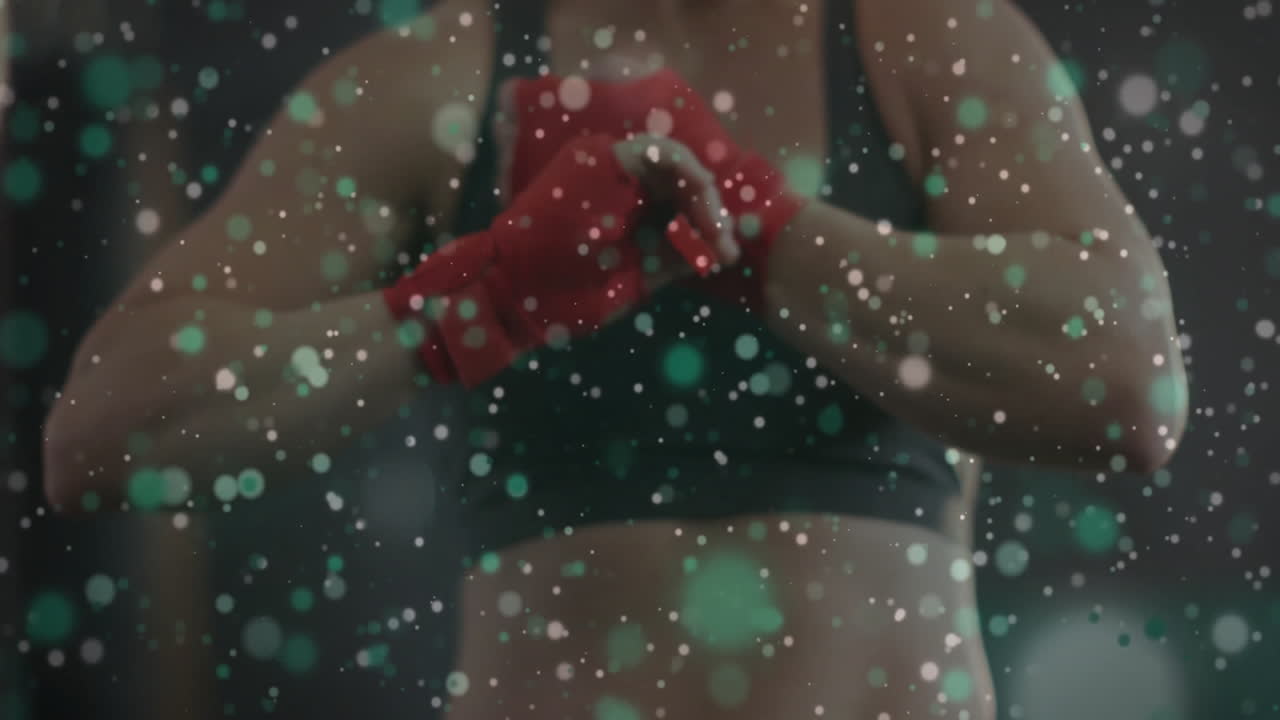 Wrapping hands with red bandages, athlete preparing for training over bokeh animation